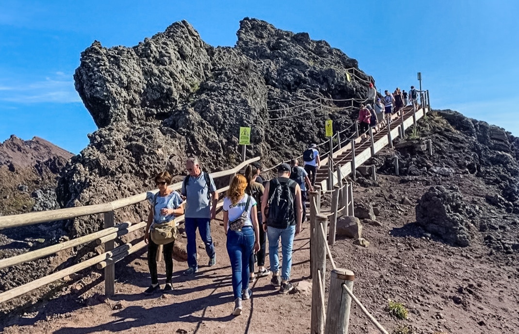 Tourists hiking on a trail at Mount Vesuvius, Italy.