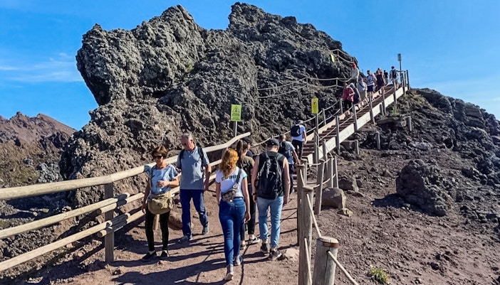 Tourists hiking on a trail at Mount Vesuvius, Italy.