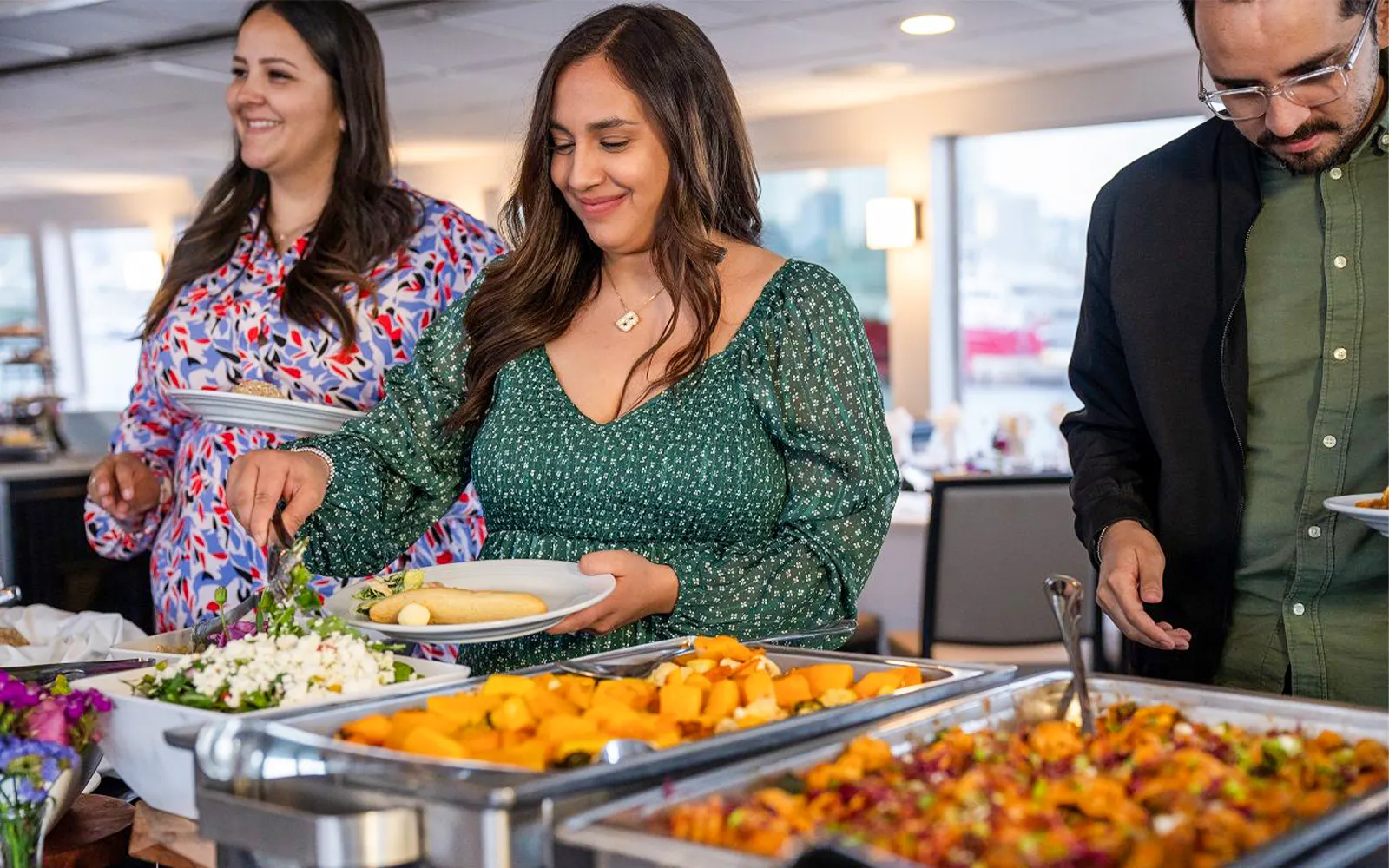 Guests serving themselves dinner on the San Diego Signature Dinner Cruise buffet.