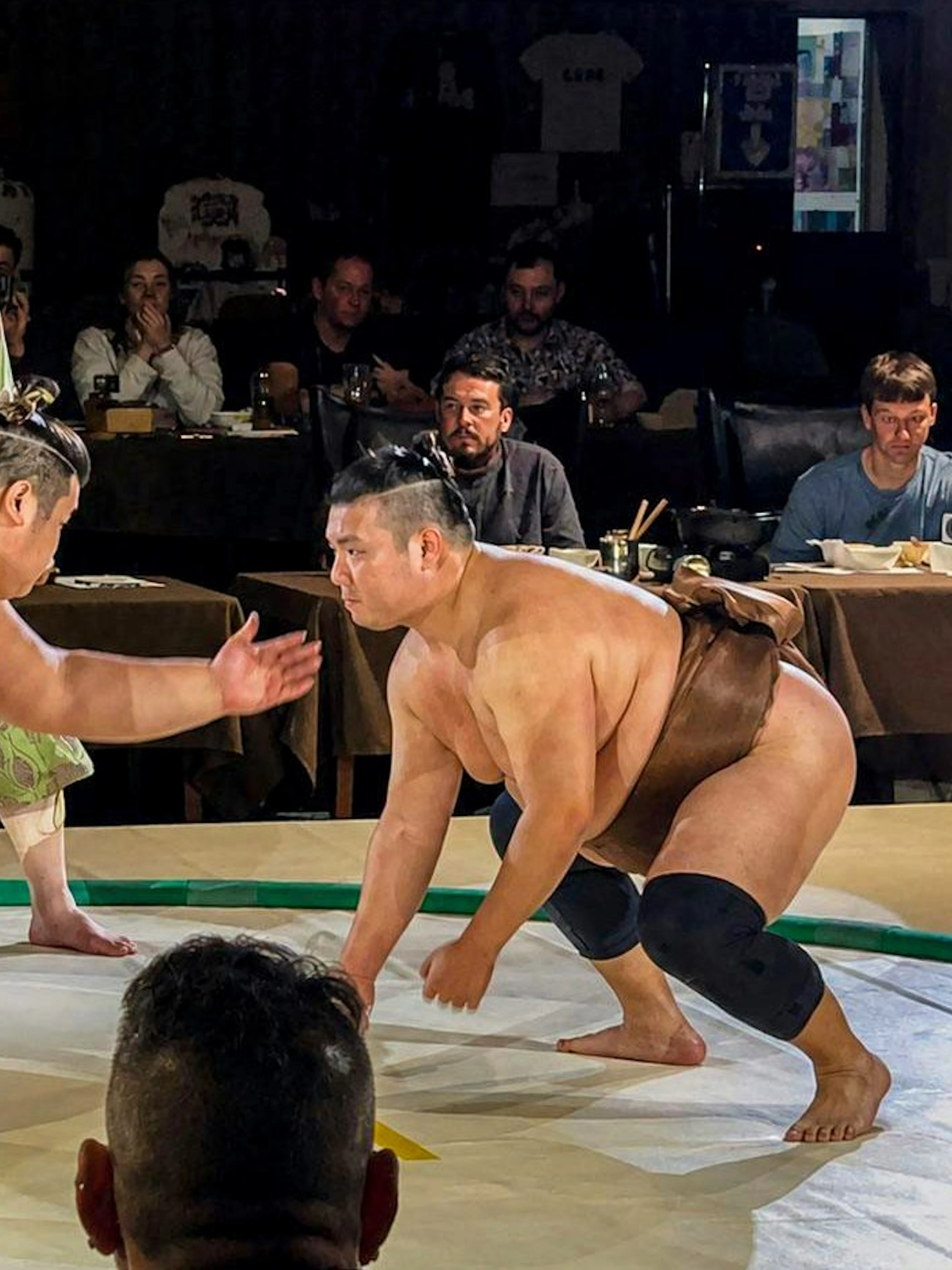 Sumo wrestlers competing in an arena during the Sumo Show & Samurai Night Experience.