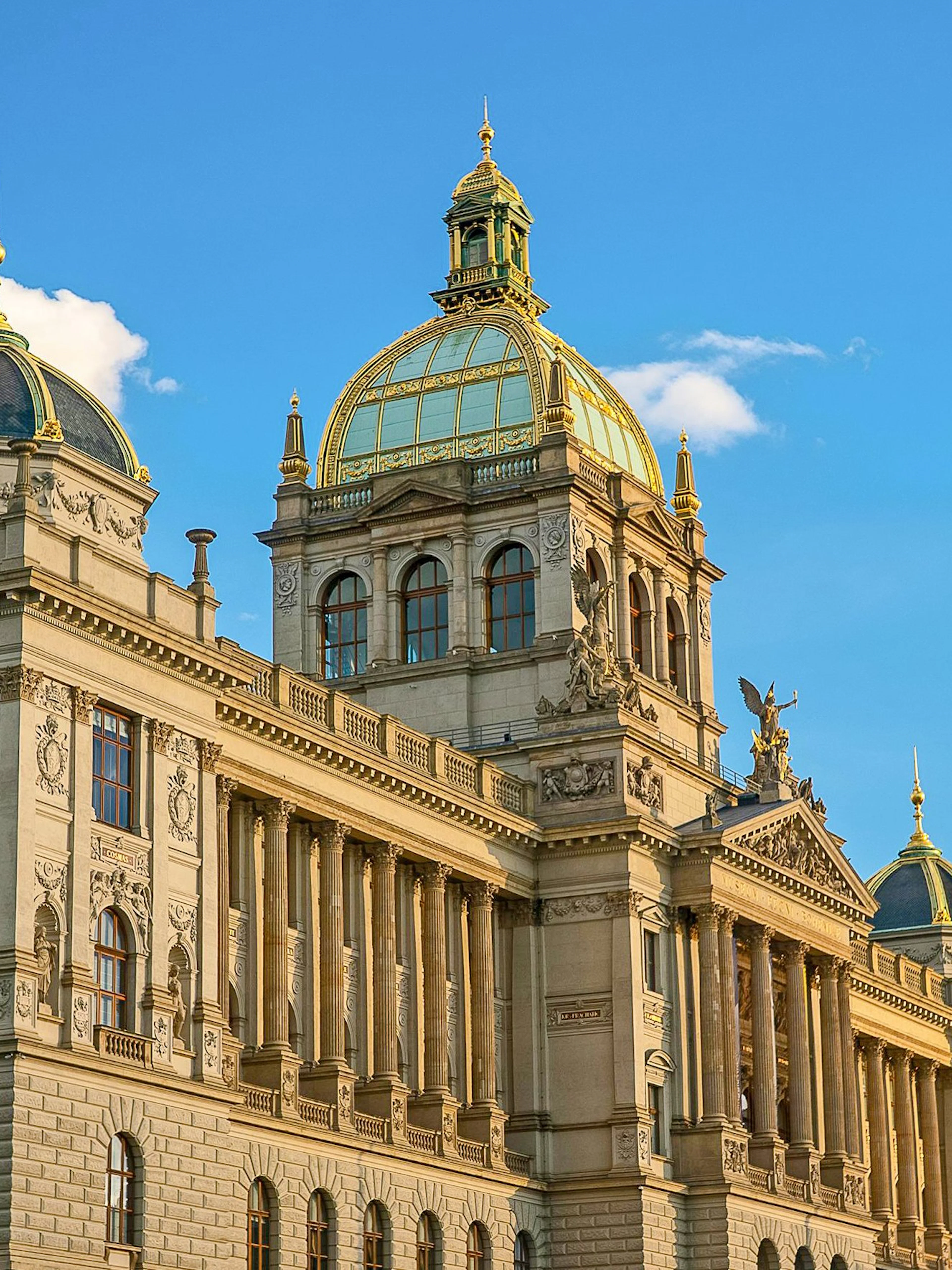 National Museum building in Prague with ornate facade under blue sky.