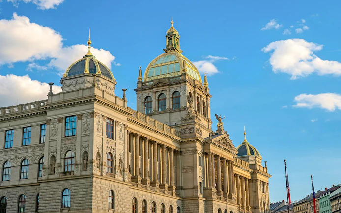 National Museum building in Prague with ornate facade under blue sky.
