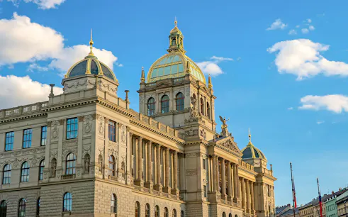 National Museum building in Prague with ornate facade under blue sky.