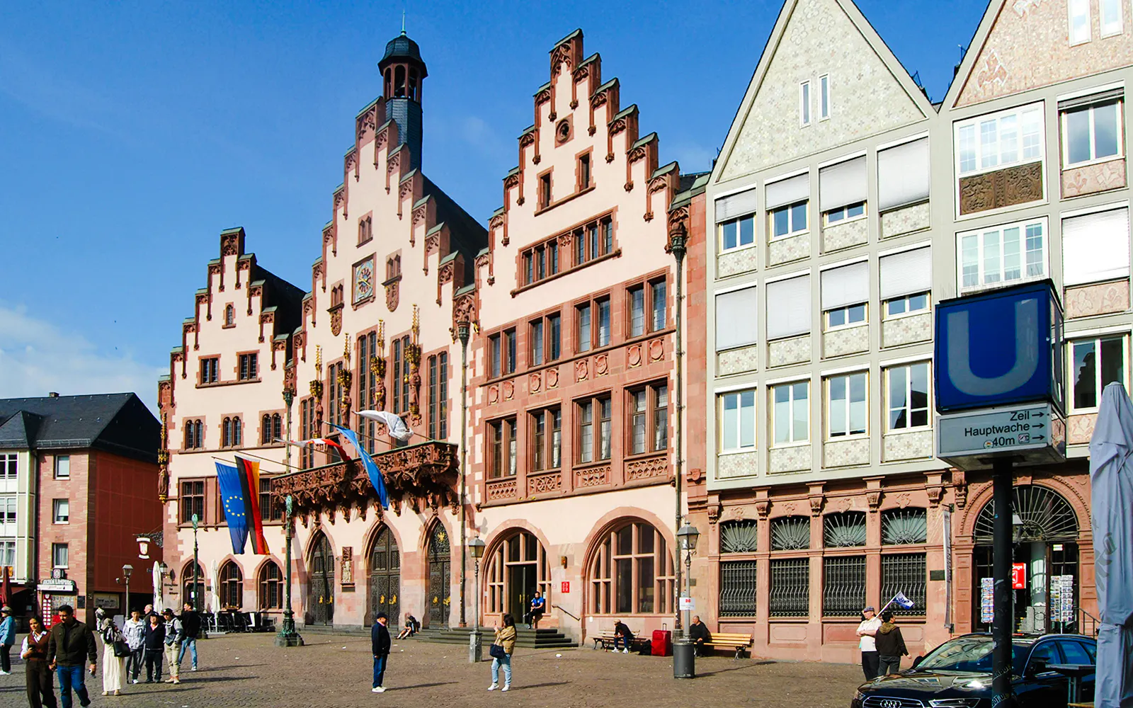 Römer city hall and Römerberg square in Frankfurt am Main with people walking.