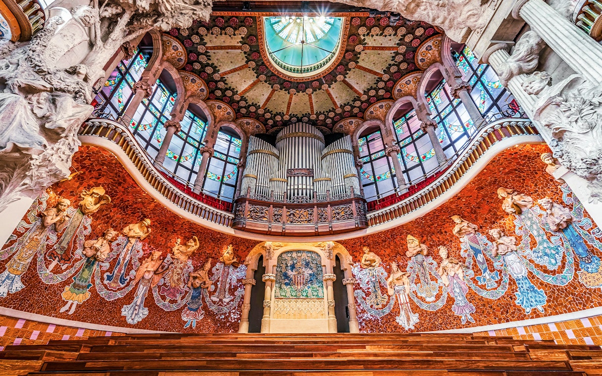 Wooden stage with stone relief and ornate organ inside Palau de la Musica Catalana, Barcelona.