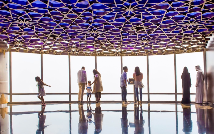 Visitors enjoying the view from Burj Khalifa Level 124 observation deck.