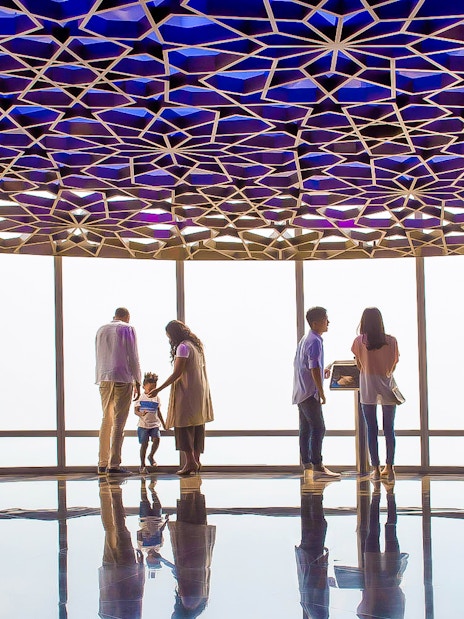 Visitors enjoying the view from Burj Khalifa Level 124 observation deck.