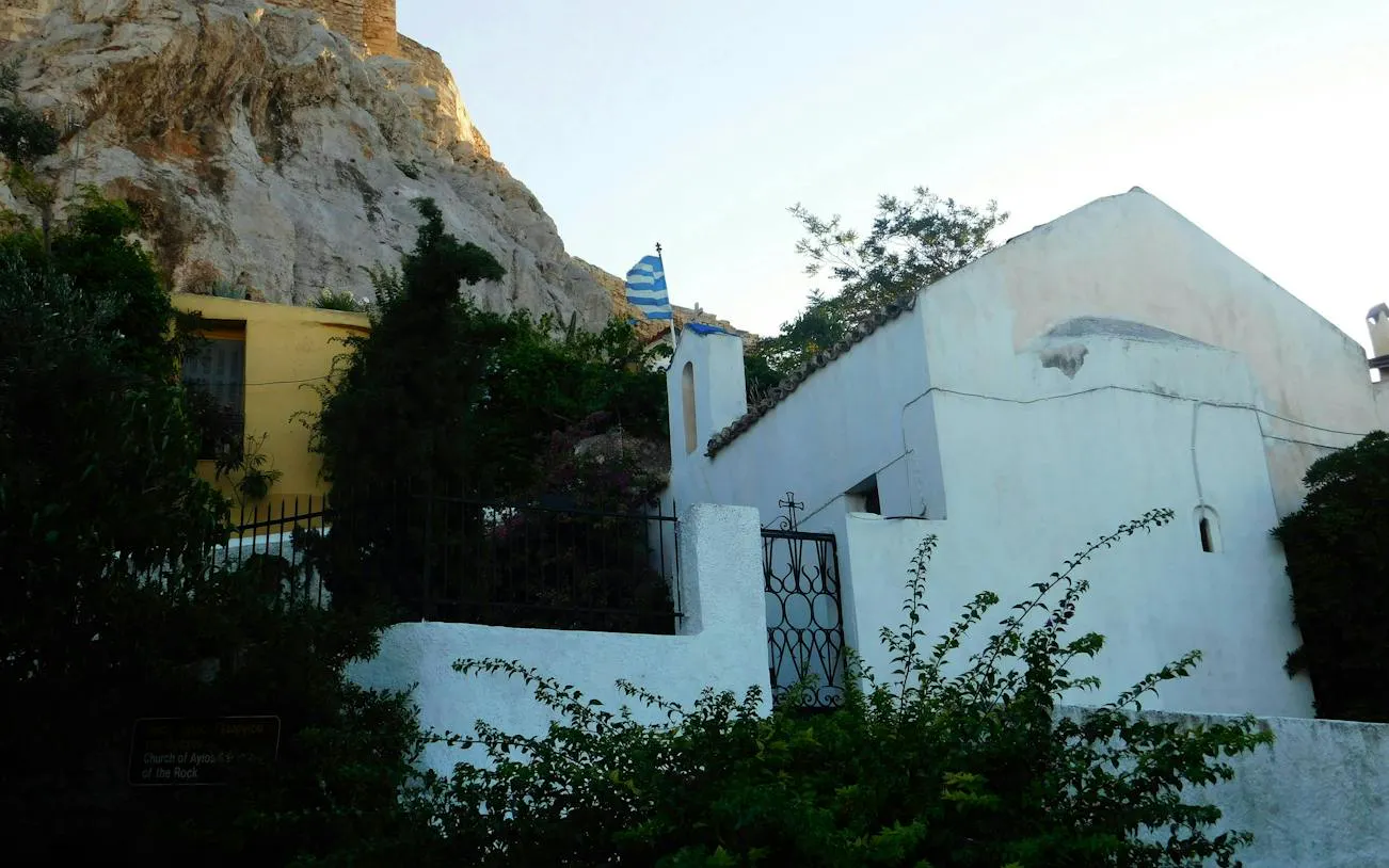 Plaka neighborhood with traditional houses and Greek flag, Athens exploration game.