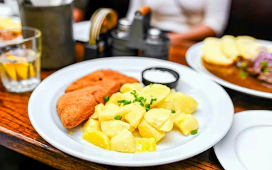 Schnitzel with potatoes on a Prague food tour plate.