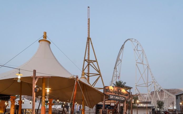 Roller coaster and Skywatch sign at Valley of Fortune, Six Flags Qiddiya City.