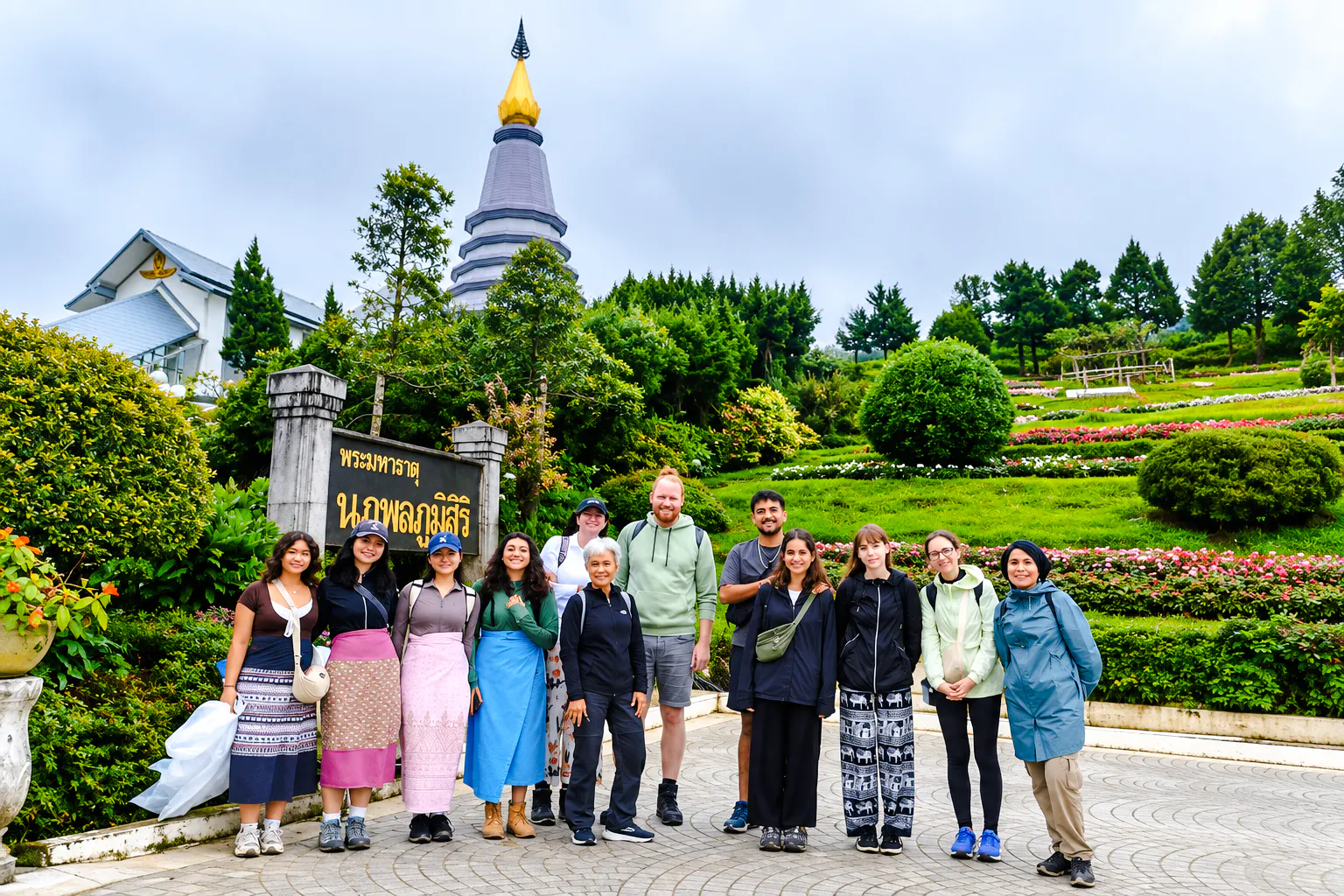 Group of tourists at Doi Inthanon National Park with a pagoda and gardens, Chiang Mai.