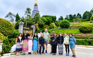 Group of tourists at Doi Inthanon National Park with a pagoda and gardens, Chiang Mai.