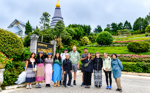 Group of tourists at Doi Inthanon National Park with a pagoda and gardens, Chiang Mai.