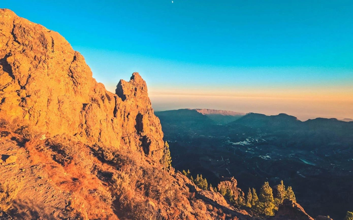 Gran Canaria volcanic landscape at sunset with distant mountains.