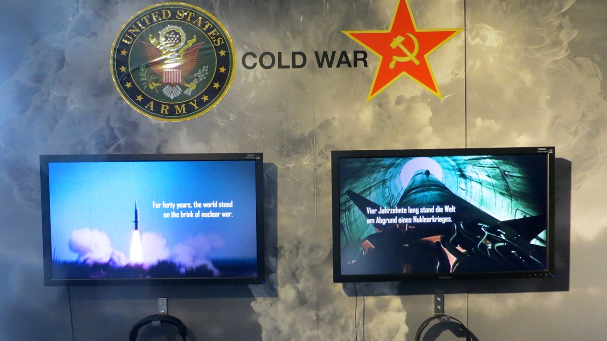 Cold War exhibit with US and Soviet symbols at Berlin Wall Museum East Side Gallery.