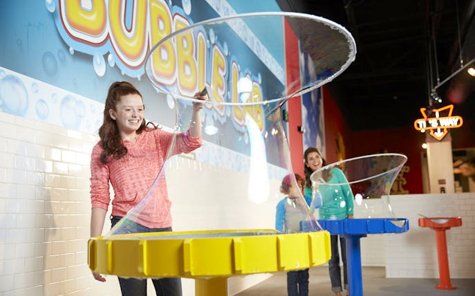 Visitors creating giant bubbles at WonderWorks Bubble Lab.