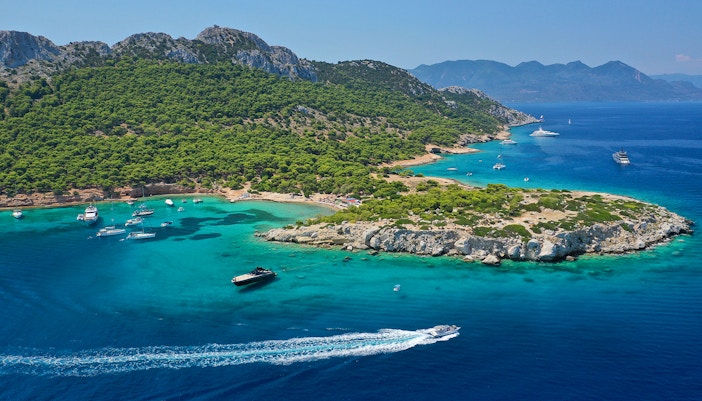 Moni Island boat tour with clear blue waters and lush greenery.