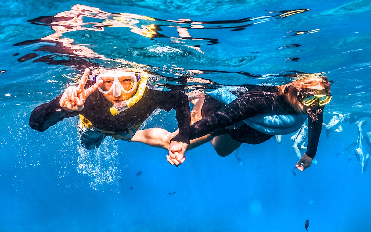 Snorkelers exploring underwater during Molokini & Turtle Adventure Raft tour, Maui, Hawaii.
