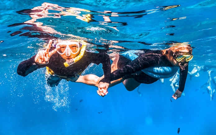 Snorkelers exploring underwater during Molokini & Turtle Adventure Raft tour, Maui, Hawaii.