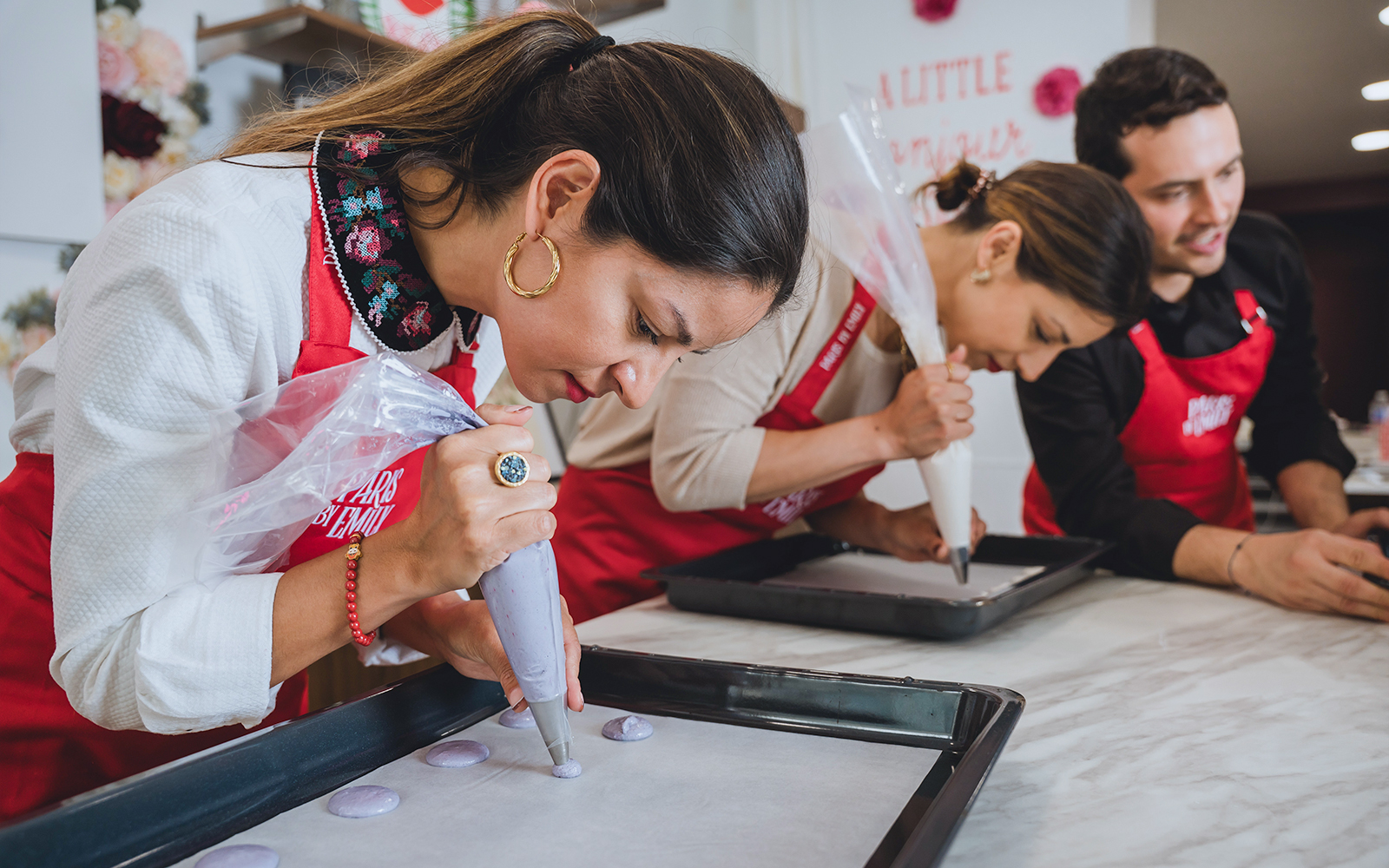 Lady piping macarons in Emily in Paris Macaron-Making Workshop.