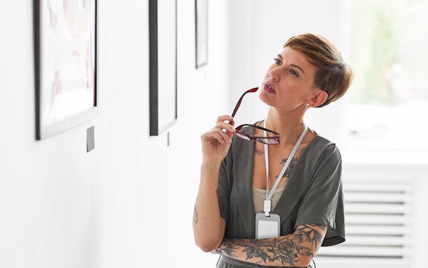 Visitor observing artwork at Fondation Louis Vuitton's Matisse: The Red Studio exhibit.