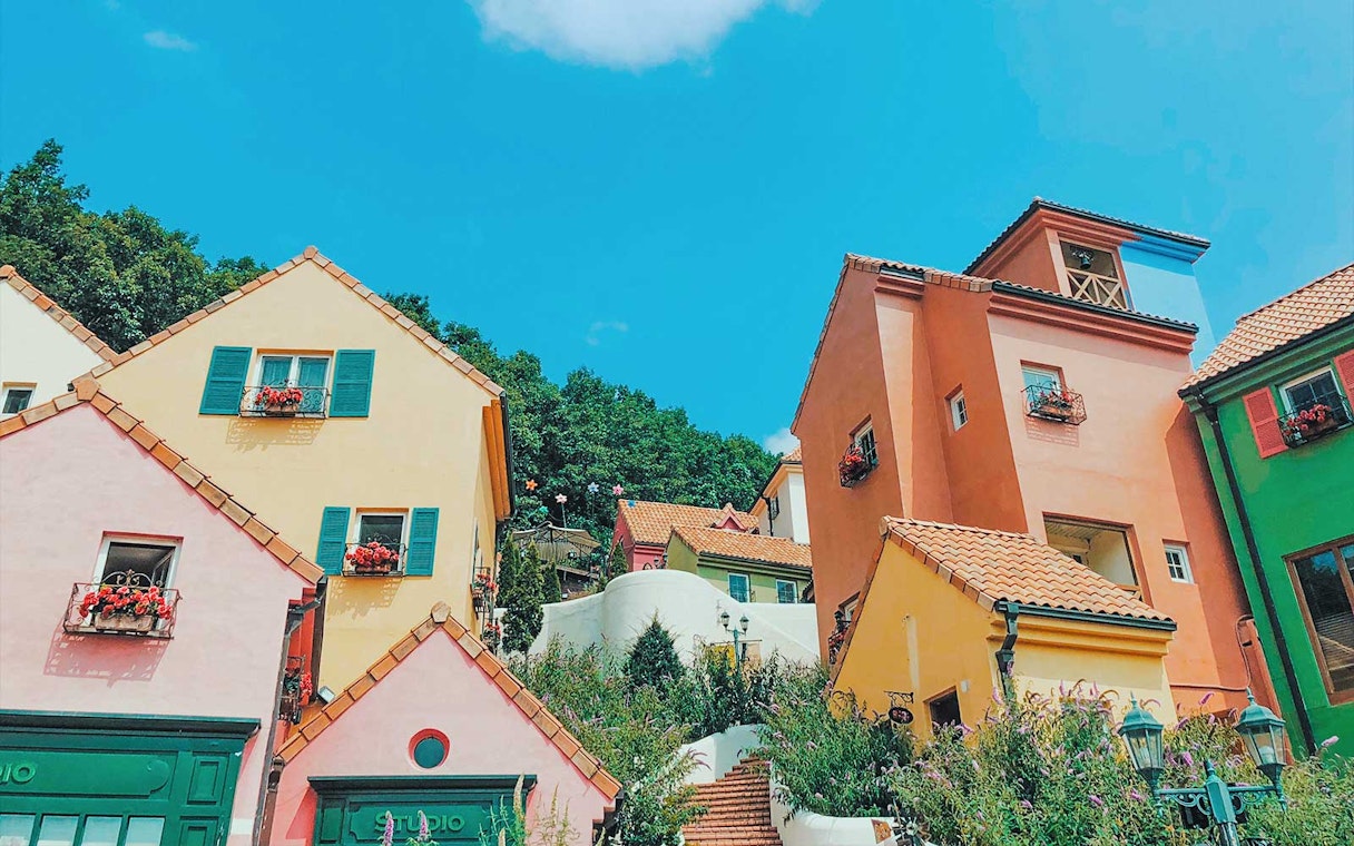 Colorful houses in Petite France & Italian Village with vibrant facades and flower boxes.