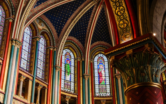 Stained glass windows and ornate arches inside Sainte-Chapelle, Paris.