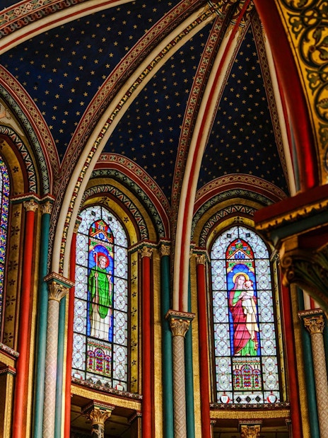 Stained glass windows and ornate arches inside Sainte-Chapelle, Paris.