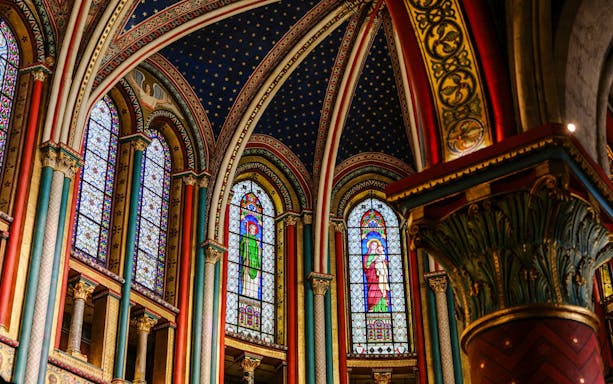 Stained glass windows and ornate arches inside Sainte-Chapelle, Paris.