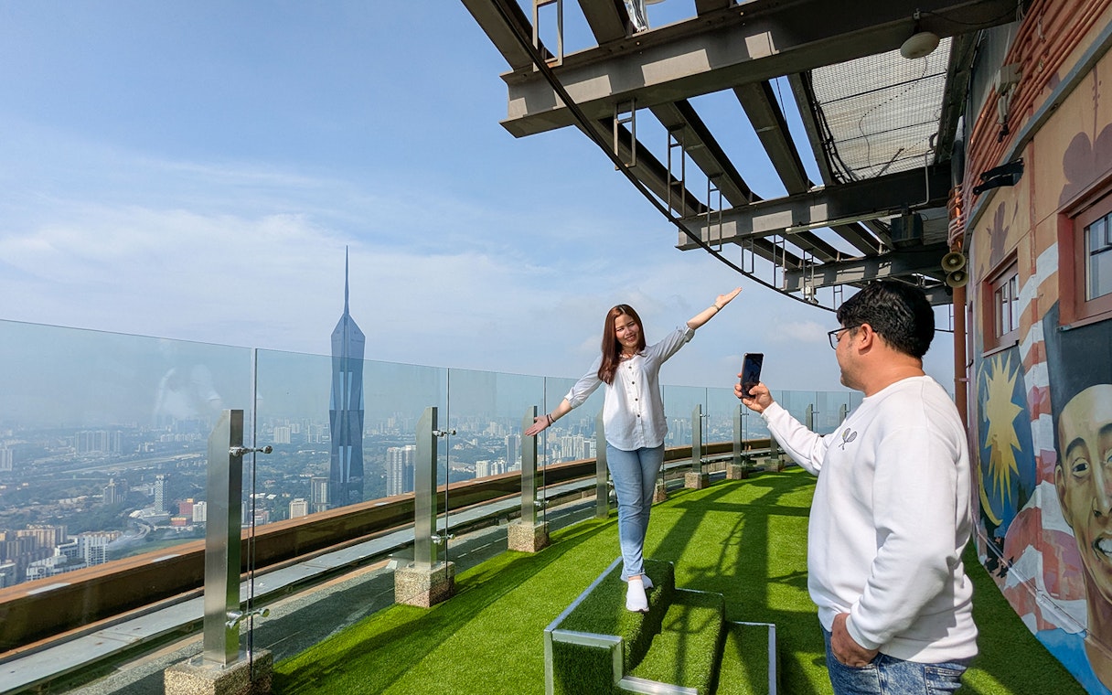 Couple enjoying view at Kuala Lumpur Tower Sky Terrace, Malaysia.