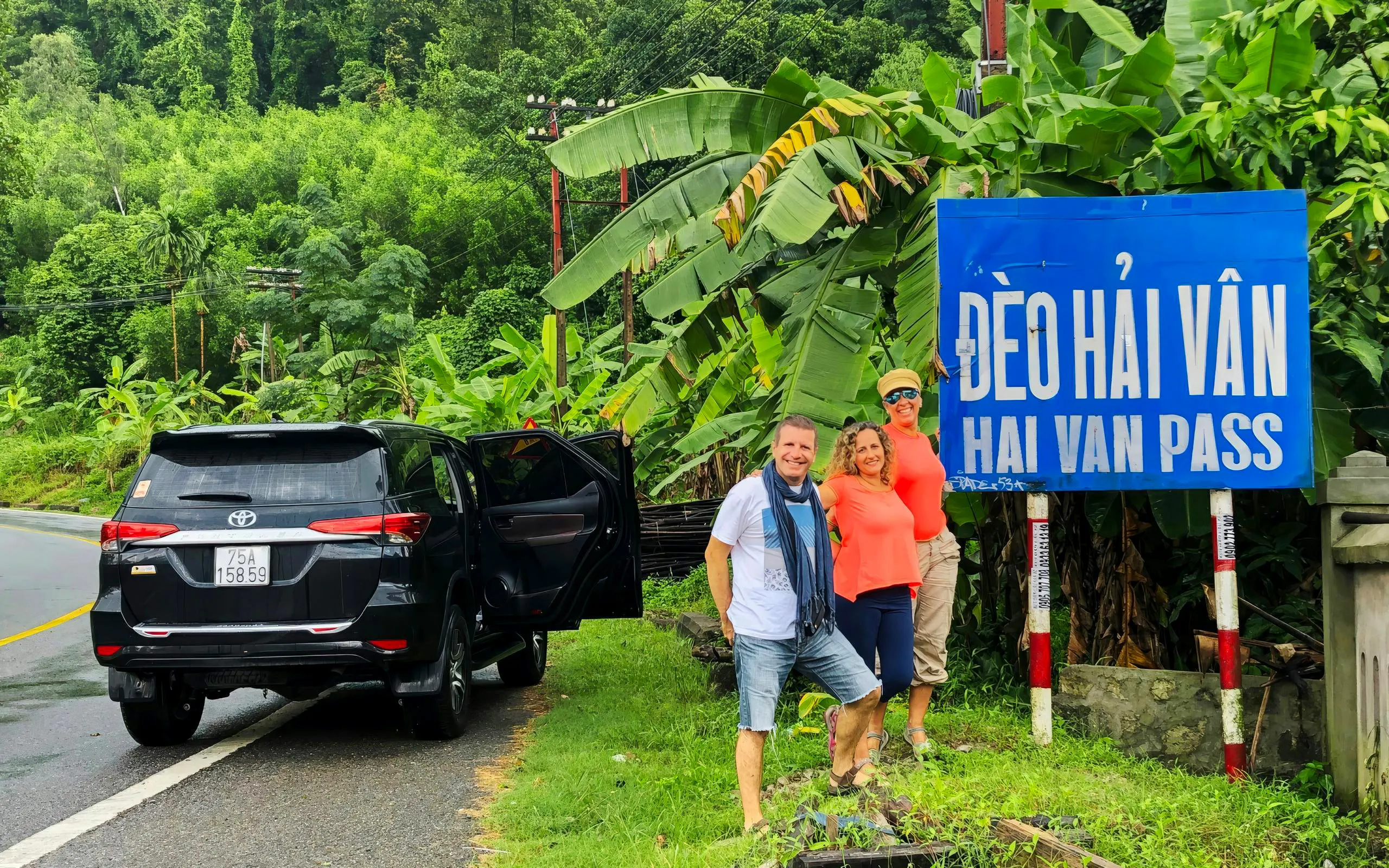 Private car tour stop at Hai Van Pass with travelers in Vietnam.