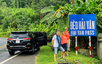 Private car tour stop at Hai Van Pass with travelers in Vietnam.