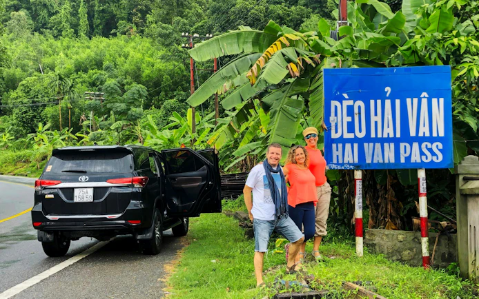 Private car tour stop at Hai Van Pass with travelers in Vietnam.