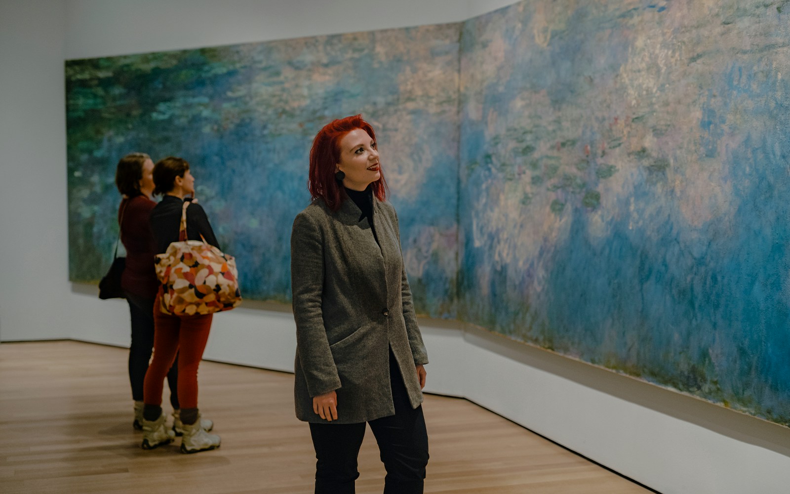 Visitor viewing Monet painting at Museum of Modern Art, New York.