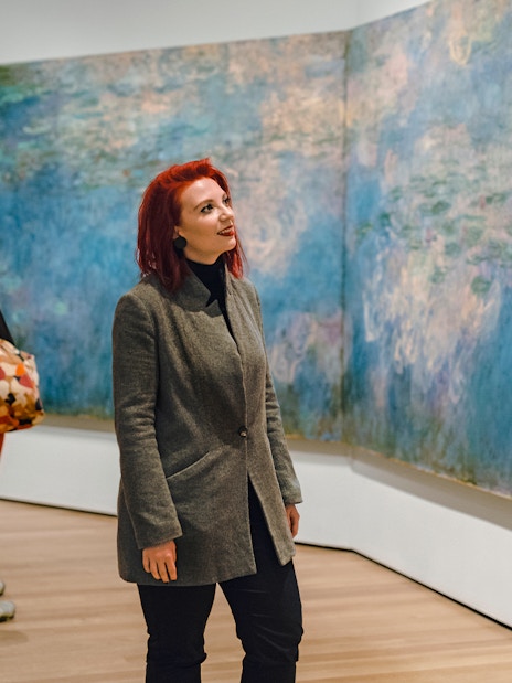 Visitor admiring Monet painting at MoMA in New York City.