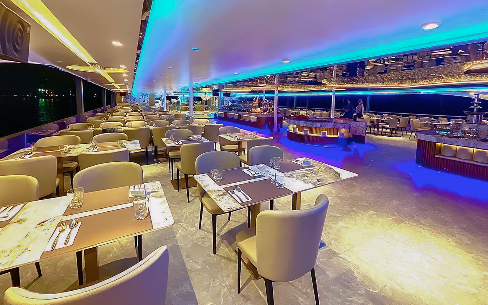 Elegant dining area on the Royal Galaxy Cruise with set tables and ambient lighting.
