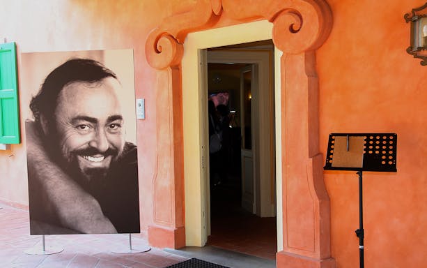 Luciano Pavarotti House Museum entrance with portrait display.