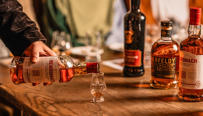 Pouring whiskey into a glass at Megget's Cellar tasting event.