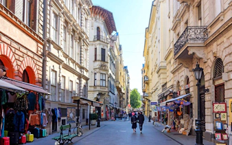 Váci utca shopping street in Budapest with people walking and shops lining the street.