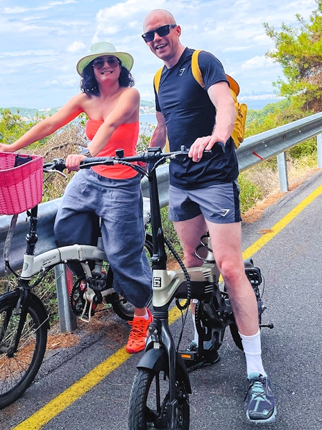 Couple on e-bikes enjoying a scenic ride on Princes Island, Istanbul.