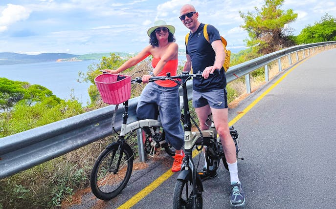 Couple on e-bikes enjoying a scenic ride on Princes Island, Istanbul.