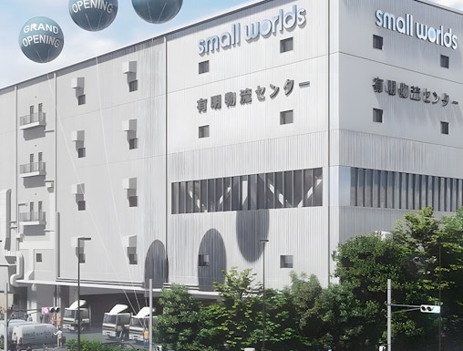 Small Worlds Tokyo building exterior with grand opening balloons.