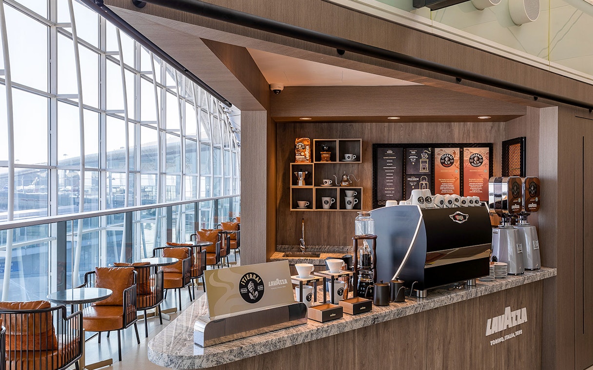 Plaza Premium Lounge coffee bar with Lavazza machine and seating area.