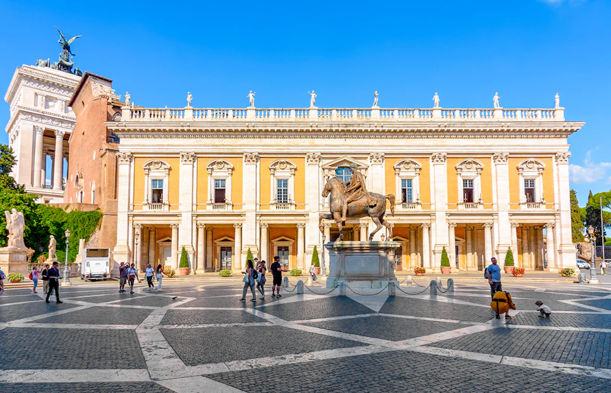 Capitoline Museums courtyard with equestrian statue and visitors in Rome.