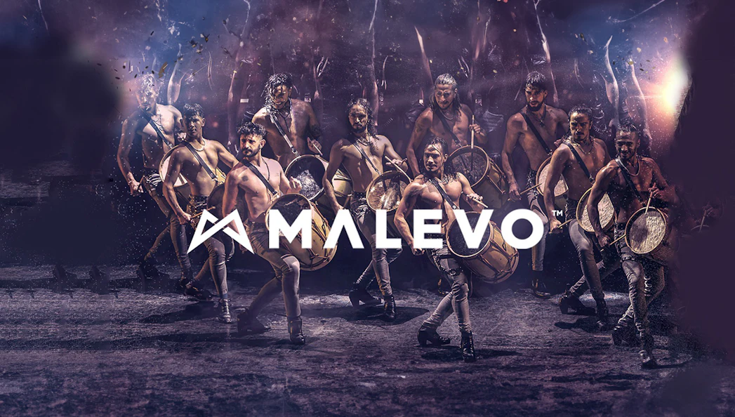 Malevo performers with drums in dynamic dance formation.