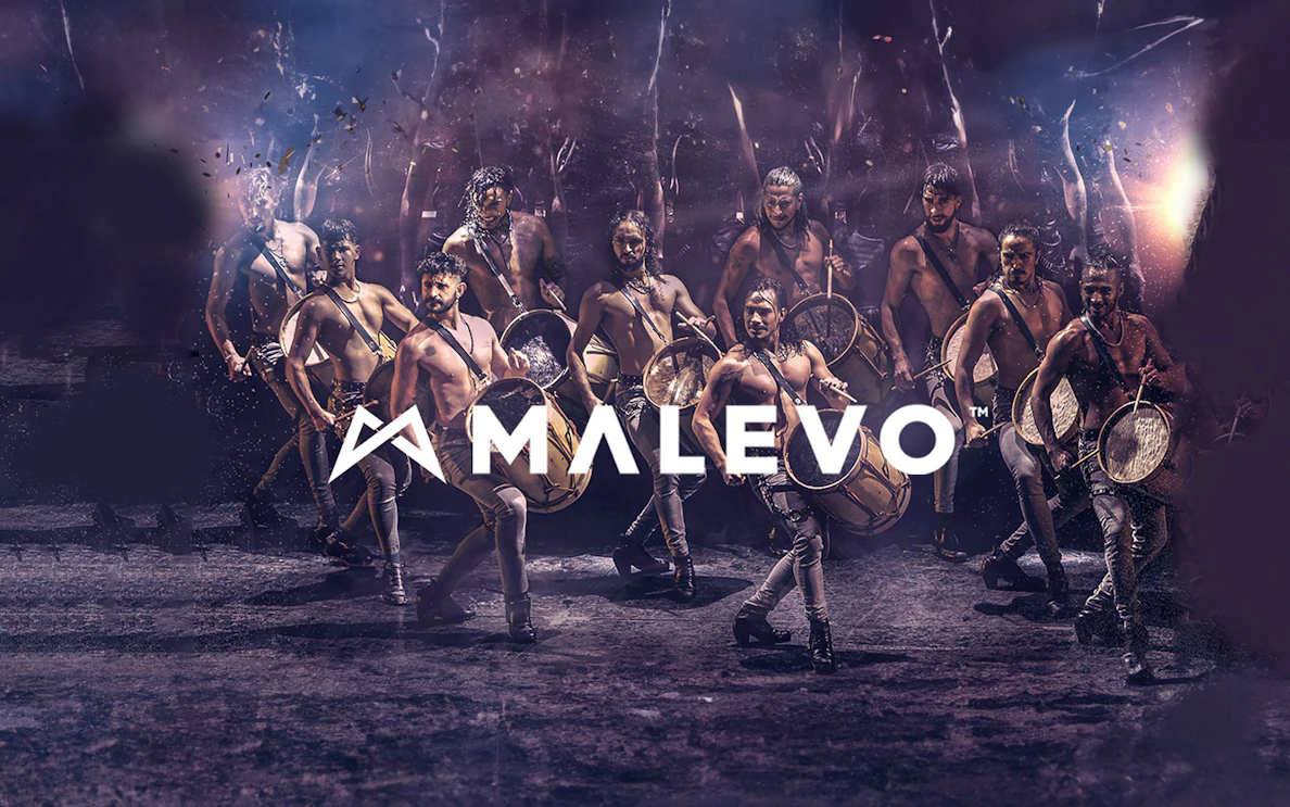 Malevo performers with drums in dynamic dance formation.