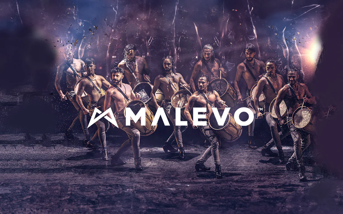 Malevo performers with drums in dynamic dance formation.