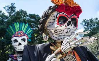 Mixquic Day of the Dead celebration with large decorated skeleton figures.