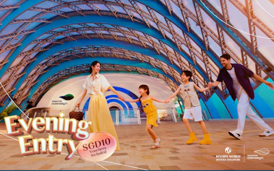 Family enjoying evening entry at Singapore Oceanarium under a colorful arched structure.