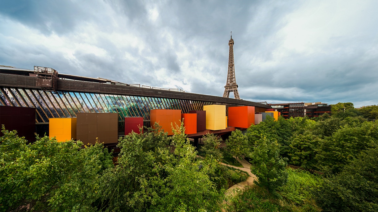 Quai Branly Museum exterior with Eiffel Tower view, Paris Seine River cruise tickets.